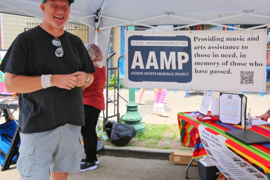 Roman in the AAMP booth at the Athens Community Arts and Music Festival